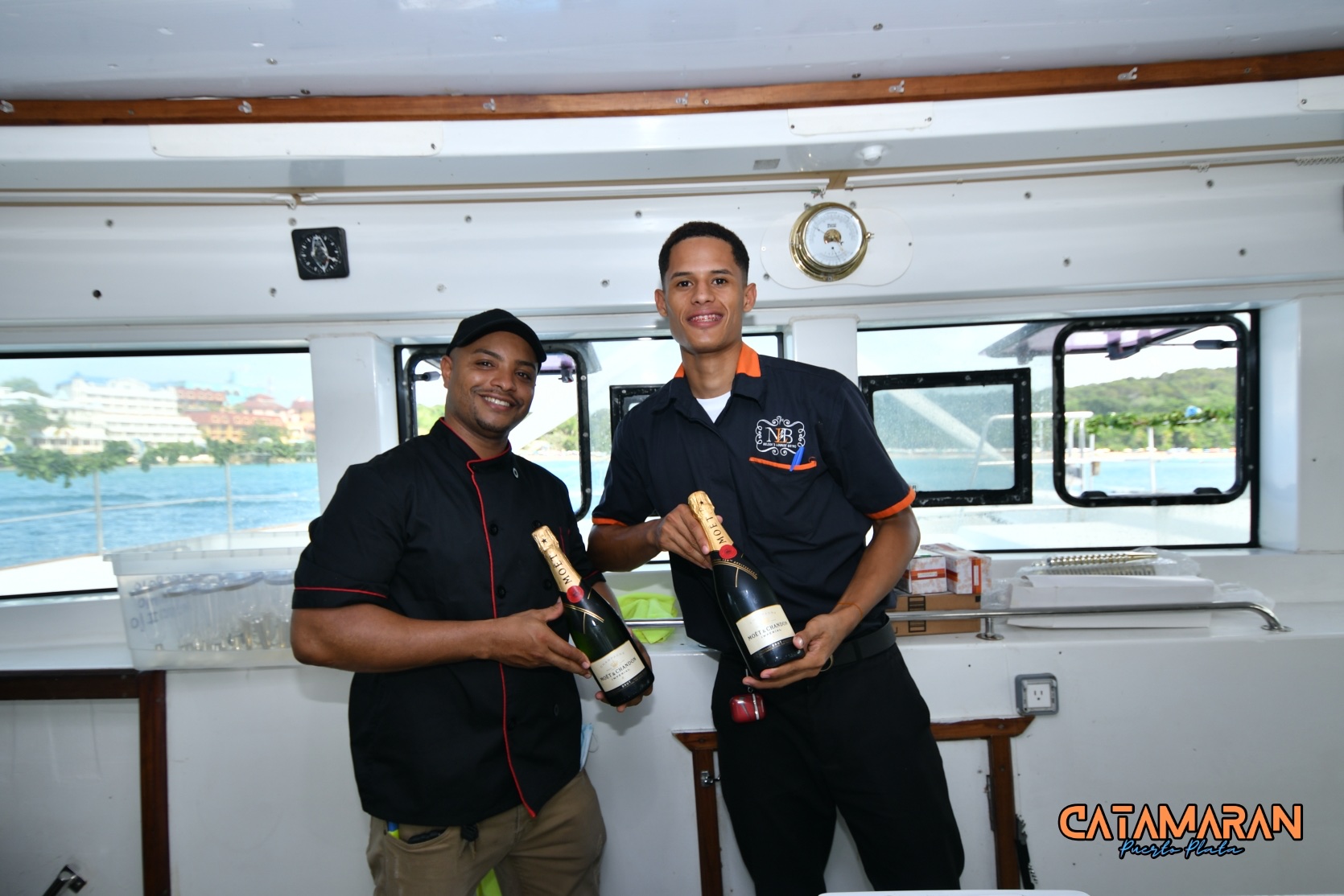 waiters with Moet bottles at the catamaran